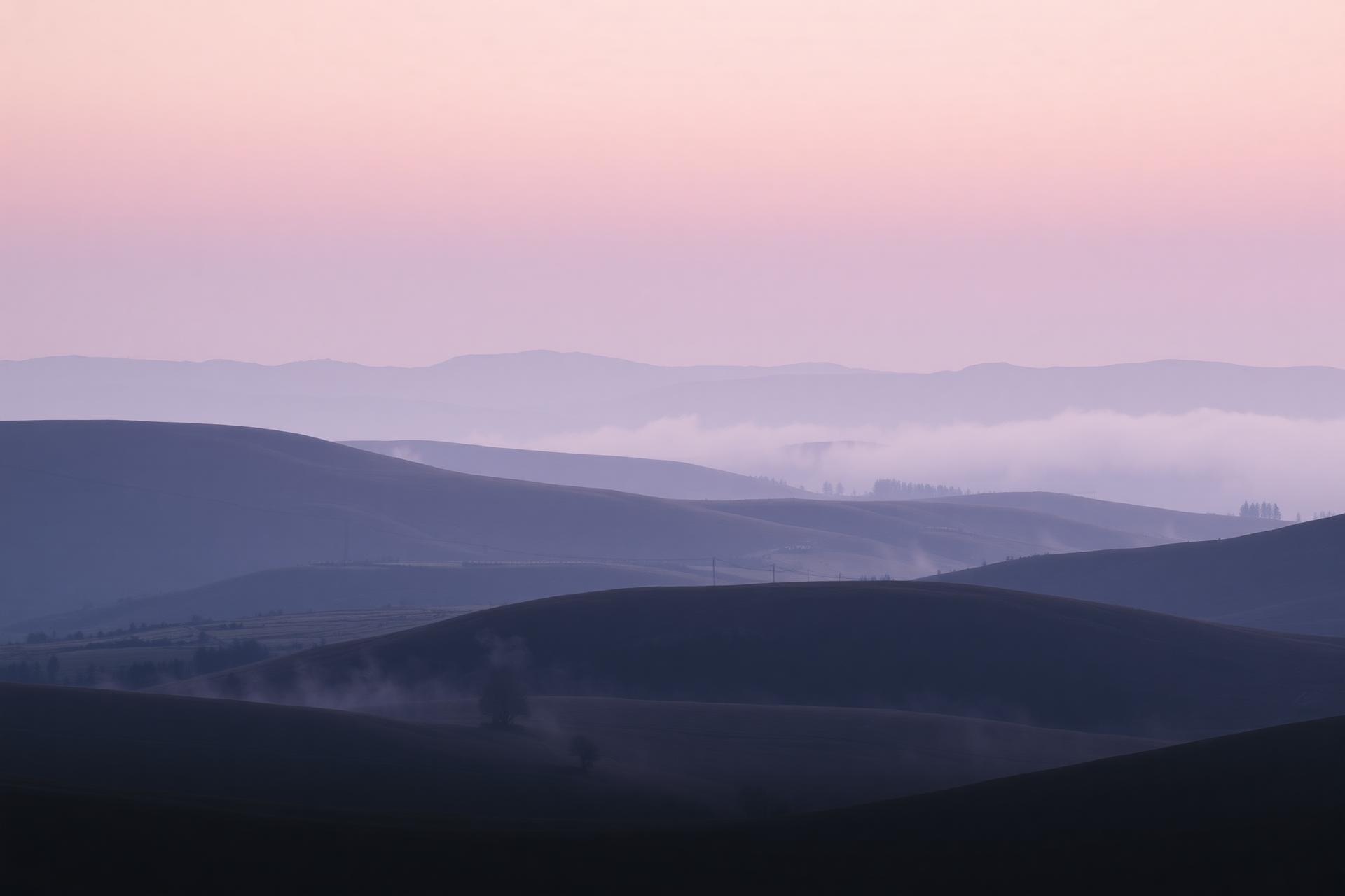 Mist over the rolling hills of the Peak District at dawn